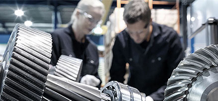 Mobil workers looking at a gear