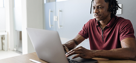 Male browsing on laptop