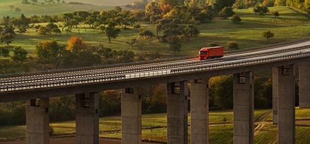 Red truck driving through the countryside