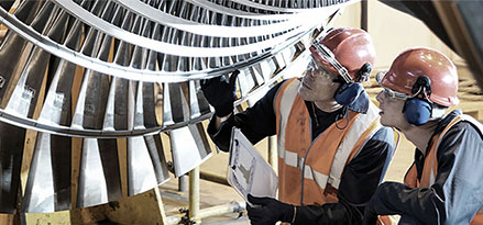 Mobil workers looking at a turbine