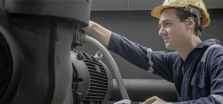 Mobil worker looking at a vacuum pump